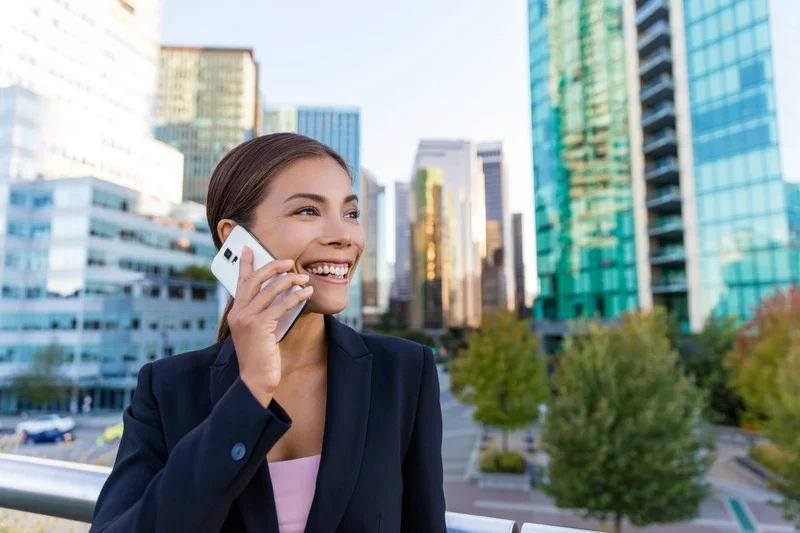 Blue Moon Marketing portfolio case study preview for Corvum, a Canadian-based VoIP provider. Image of a smiling businesswoman on a phone call in the city, symbolizing communication, connection, and marketing growth.