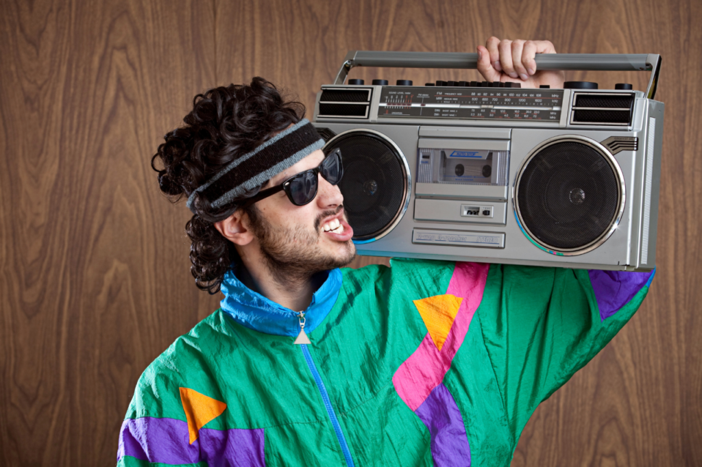 Blue Moon Marketing blog image of a man in retro 80s tracksuit with boombox, representing nostalgia-driven and culturally fluent campaigns that connect brands to audiences through shared memories.