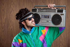 Blue Moon Marketing blog image of a man in retro 80s tracksuit with boombox, representing nostalgia-driven and culturally fluent campaigns that connect brands to audiences through shared memories.