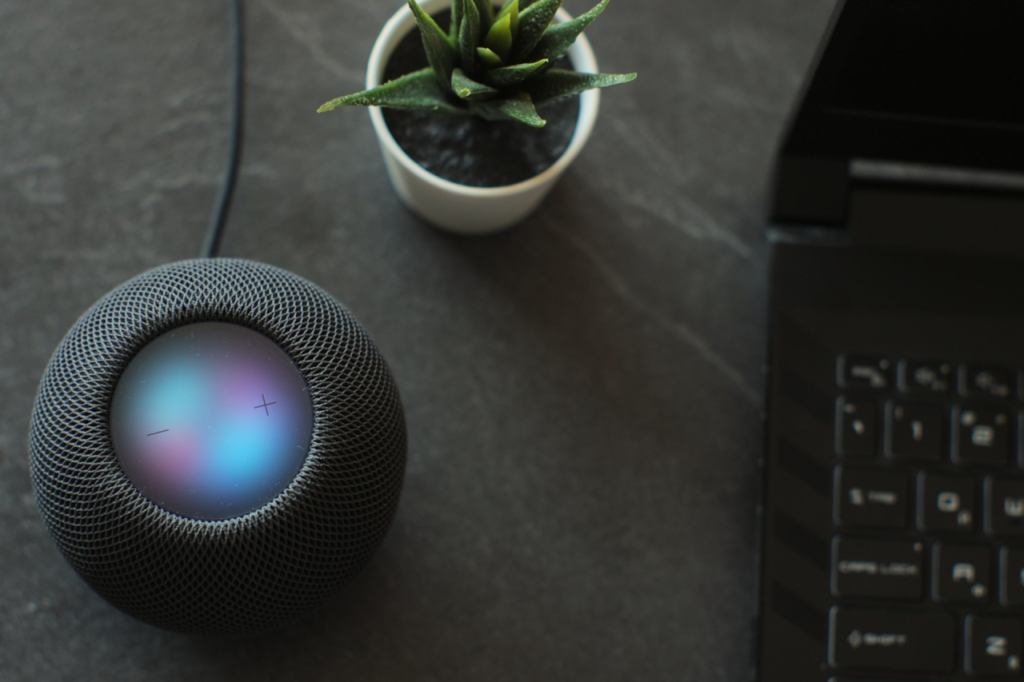 Blue Moon Marketing blog image of a smart speaker and laptop, representing AI voice search, conversational GEO, and why brands need to adapt their digital marketing strategies.
