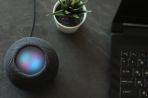 Blue Moon Marketing blog image of a smart speaker and laptop, representing AI voice search, conversational GEO, and why brands need to adapt their digital marketing strategies.